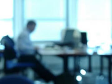 Blurred photo of person at an office desk